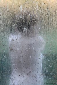 backwm naked woman through dirty window