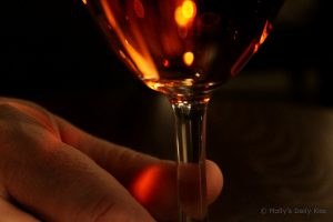rosawm fingers holding stem of wine glass macro shot