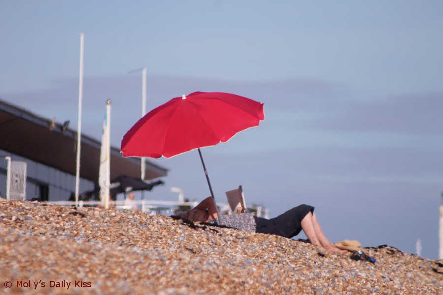 Red umbrella on Hastings beach