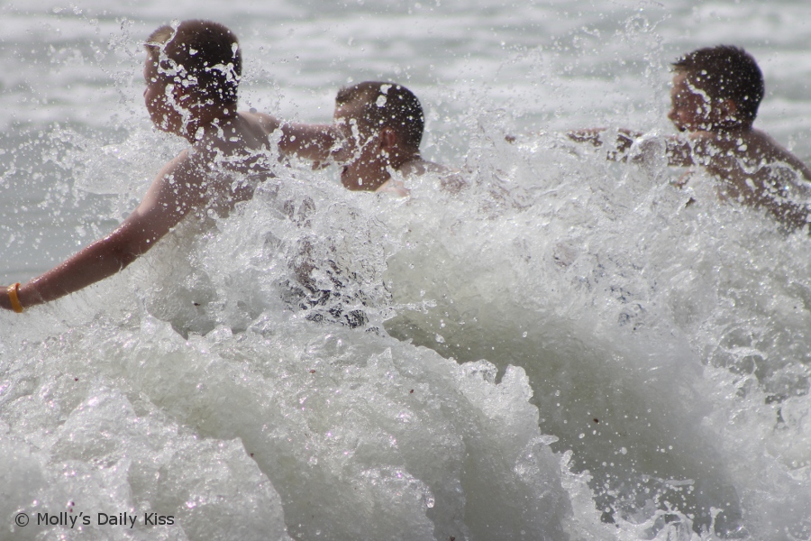 Boys playing in the surf on Hastings beach