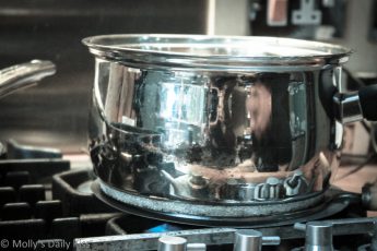 reflection of the kitchen in a saucepan