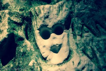 Spooky face carved in to cave wall