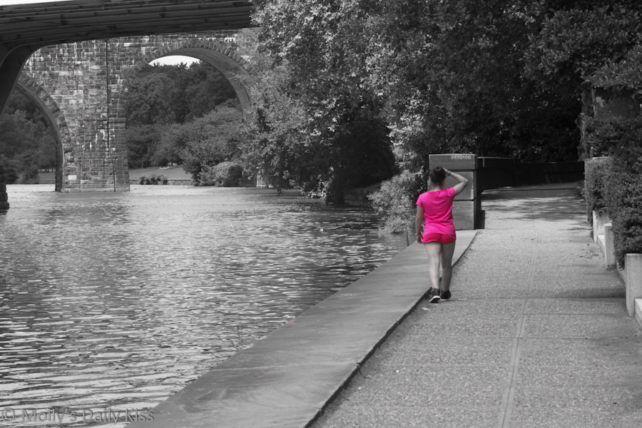 Young girl walking by the river