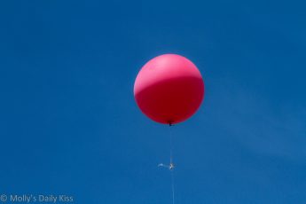 Red balloon against blue sky