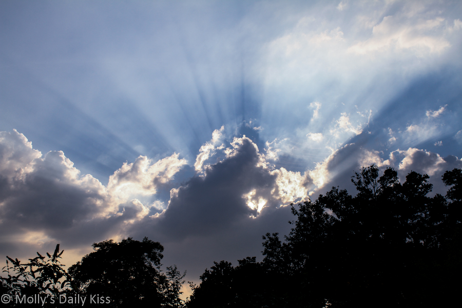 Sun rays bursting through storm clouds