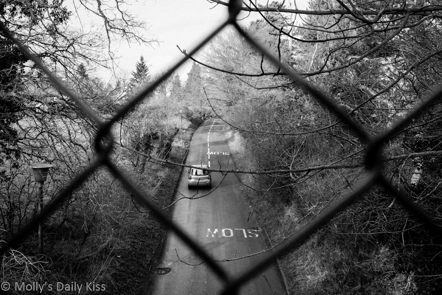 wire fence over road black and white