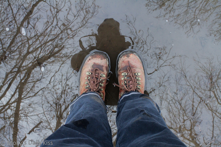 reflection of my in walking boot in a puddle