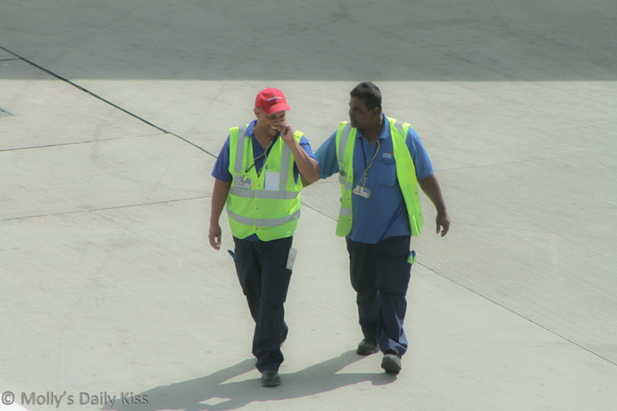 Friends at work, airport workers