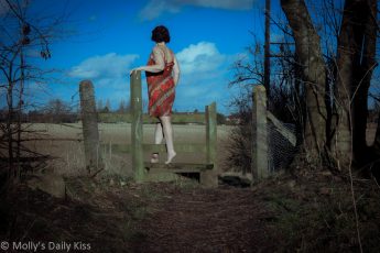 Woman stepping over stile - self portrait