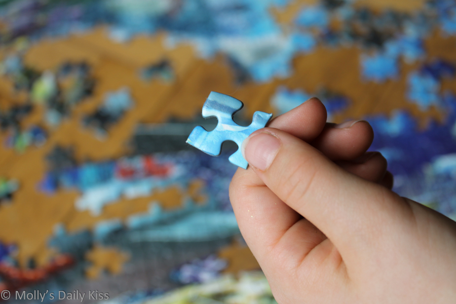 child holding piece of puzzle