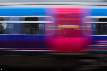 Blurred train rushing through station