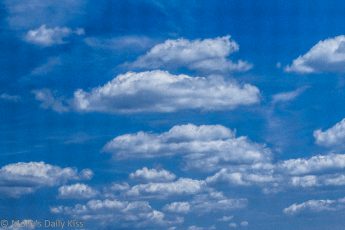 Fluffy white clouds in blue sky