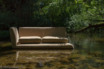 Abandoned sofa in a river