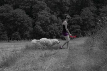 Woman walking dog carrying red lead