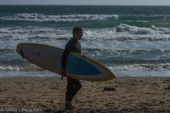 Man on compton beach with surf board