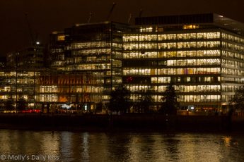 Office lights reflected in river thames