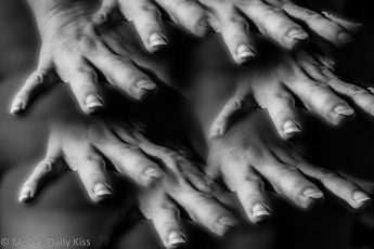 Self portrait of hands reaching out touching