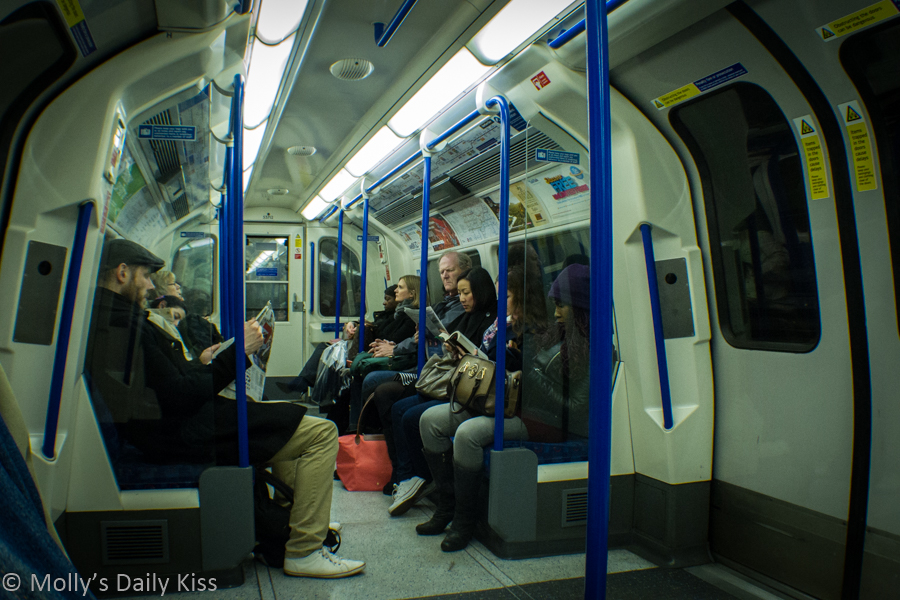 People sitting silent on the London underground
