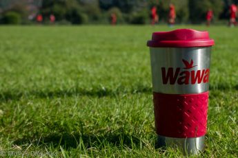 Wawa coffee cup on football field in England