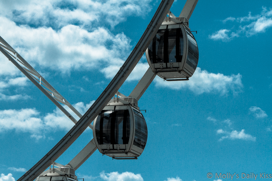 Empty Ferris wheel pods brighton against blue sky