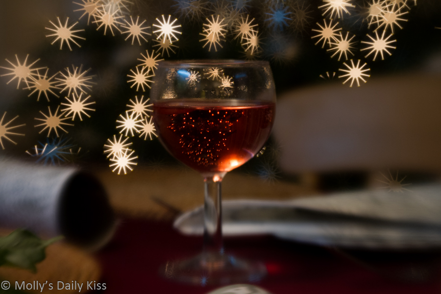 Red sparkling drink with bokeh christmas lights Merry Christmas
