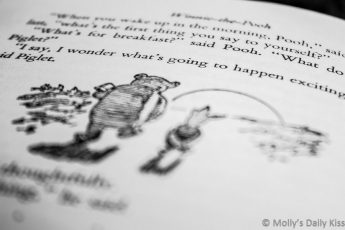 Black and white shot text in winnie the pooh book where they talking exciting things