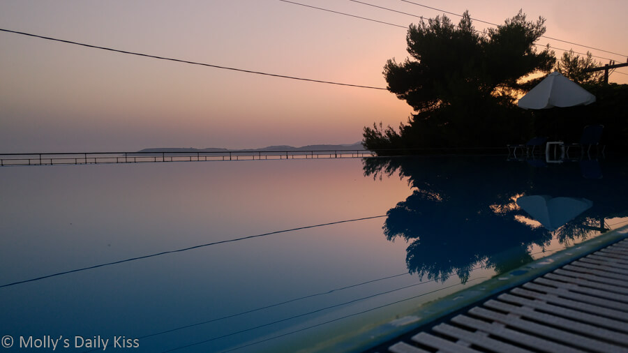 reflection of sunset in swimming pool in Kefalonia greece. Image title Allied