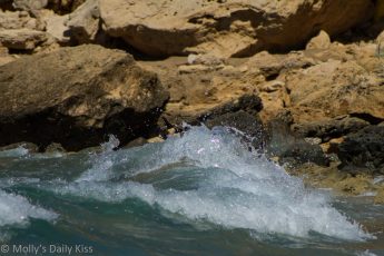 Waves breacking over rocks