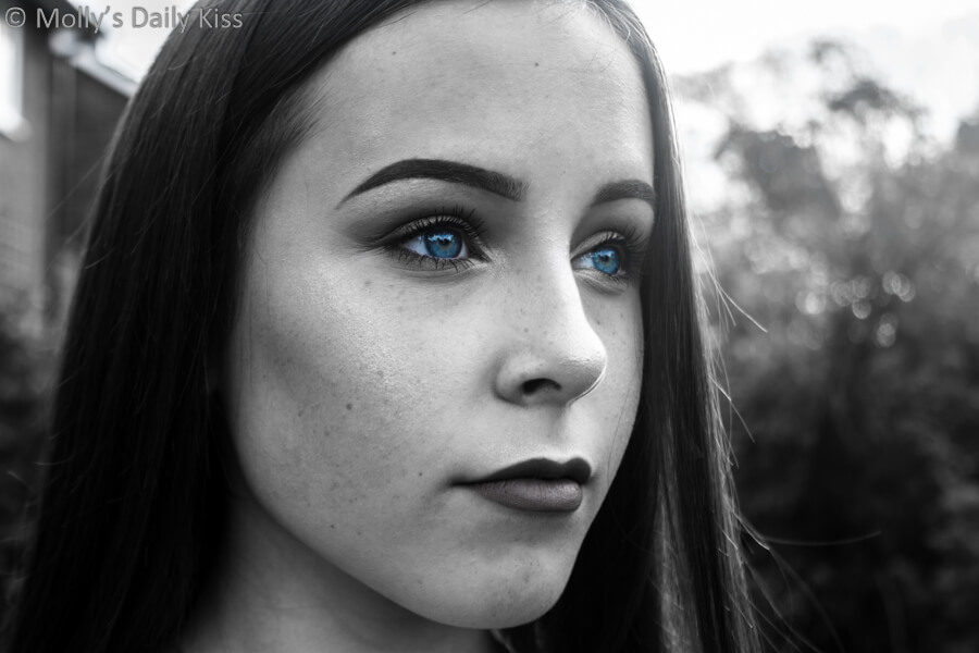 Black and white of young girl with colour blue eyes sight