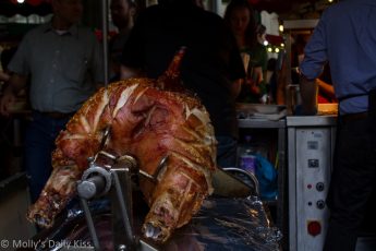 pig pork roasting on a spit in Borough market