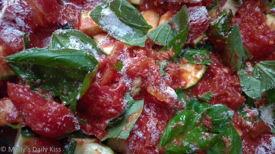 Bright red tomate and basil leaves for dinner