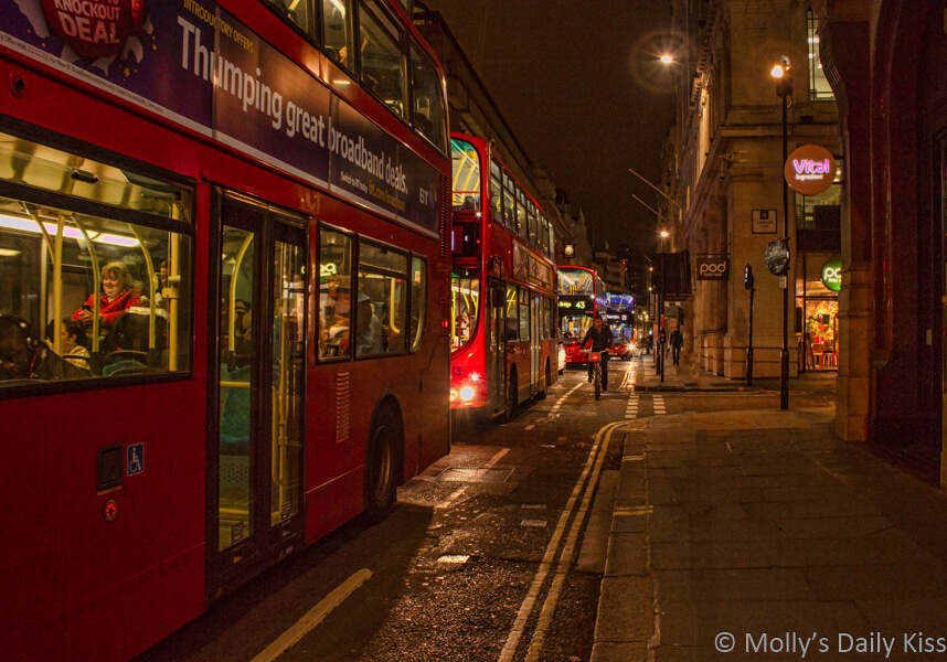 London buses in a row in the night for post called Bus Ride