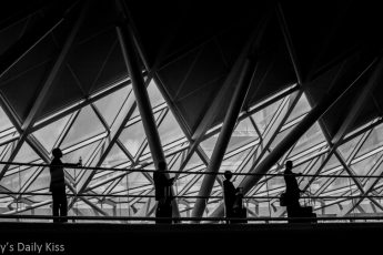silhouette of 4 people on the walkway at Kings Cross Station