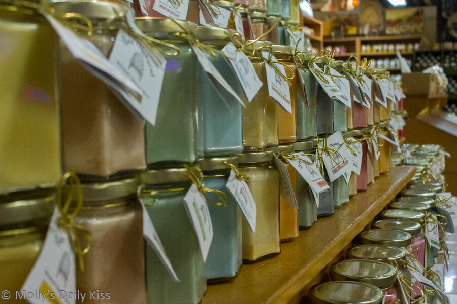 rows of jars of coloured honey