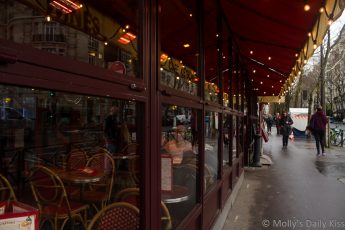 Reflection of lights and poeple in Paris cafe window