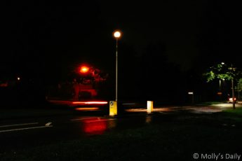 Street lights at night reflected in wet road