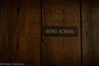 Old door with sign that says Song school