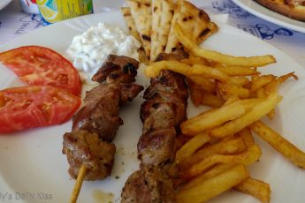 Plate of greek souvlaki, chips, pitta bread good food