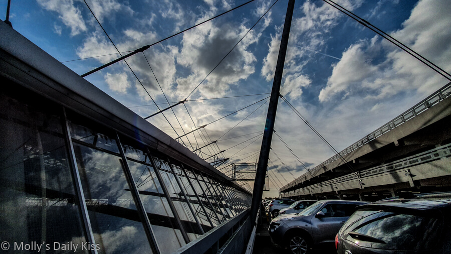 sky reflected in windows of galleria car park hertfordshire