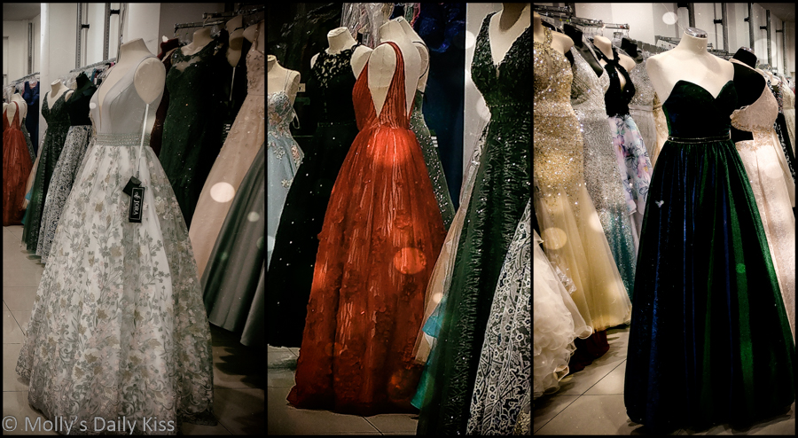 Triptych of ball gown dresses in the shop