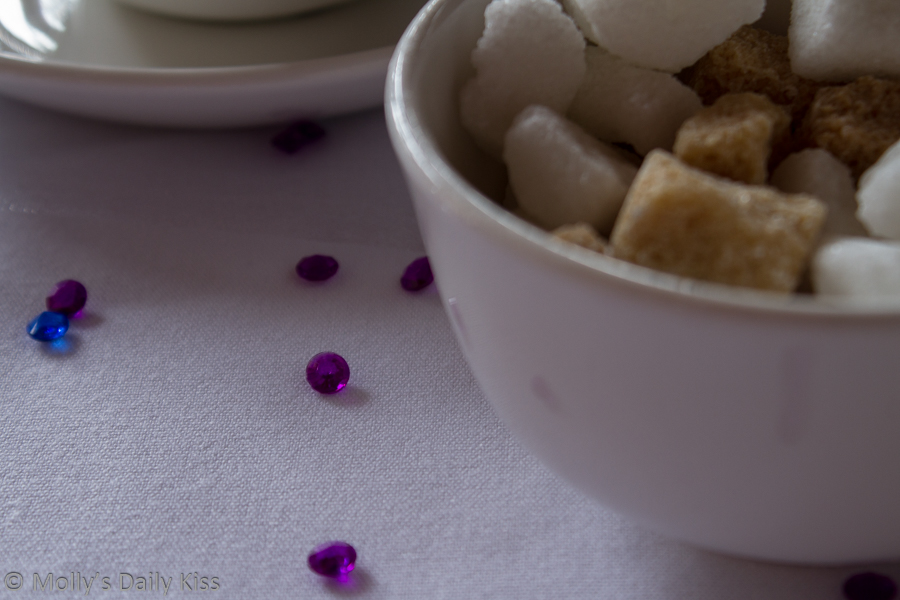 Sugar cubes in a sugar bowl on table