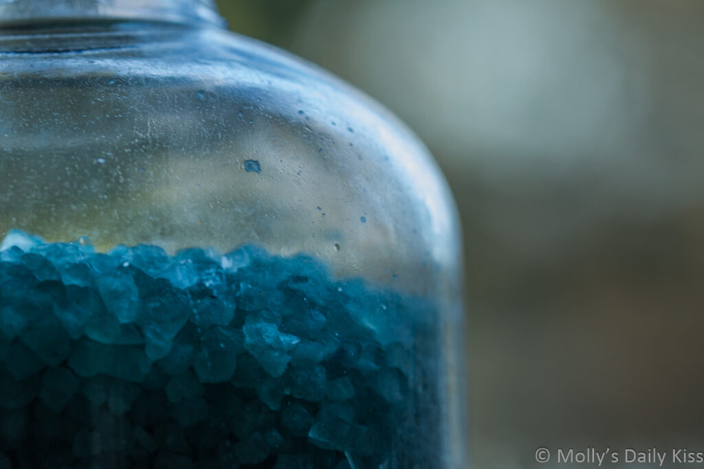 blue bath salts in glass jar
