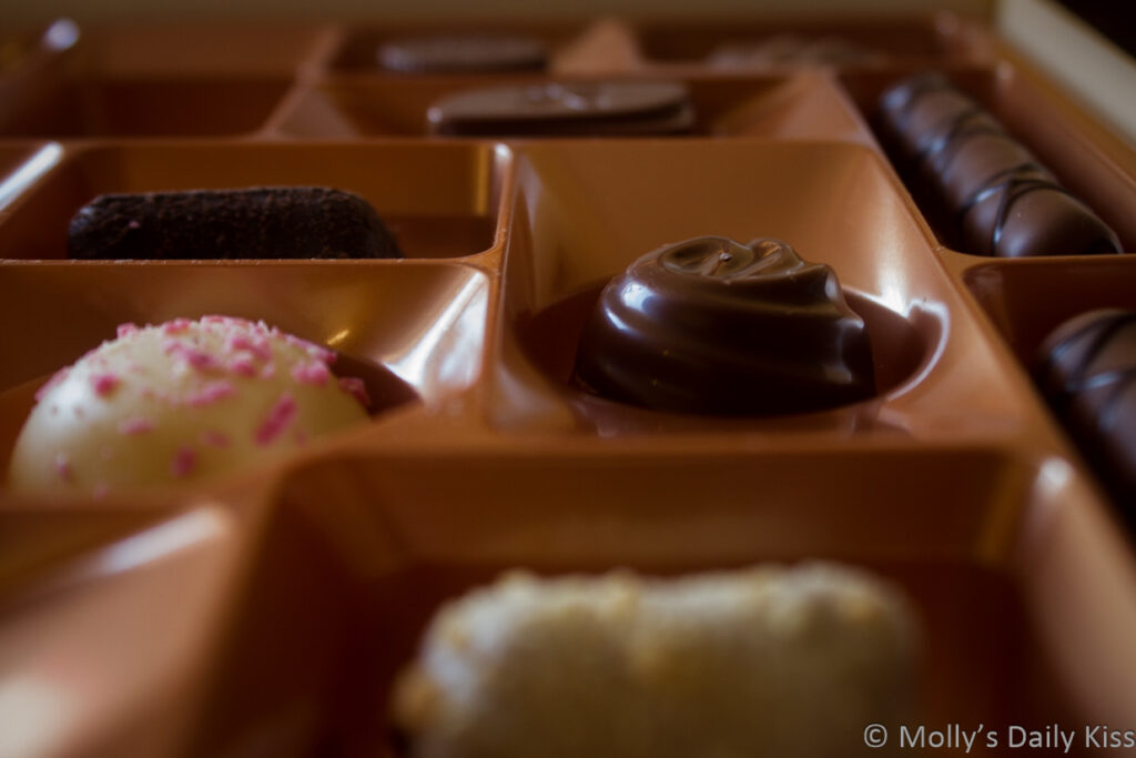 Close up shot looking across the top of a box of chocolates