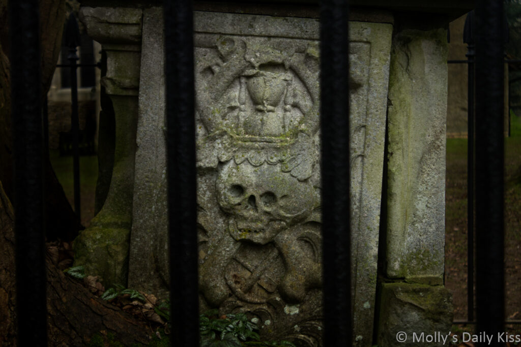 Skull and crossbones on tombstone of the dead