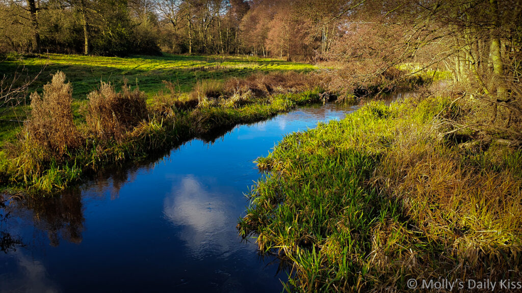 cloud reflected in moving water of river