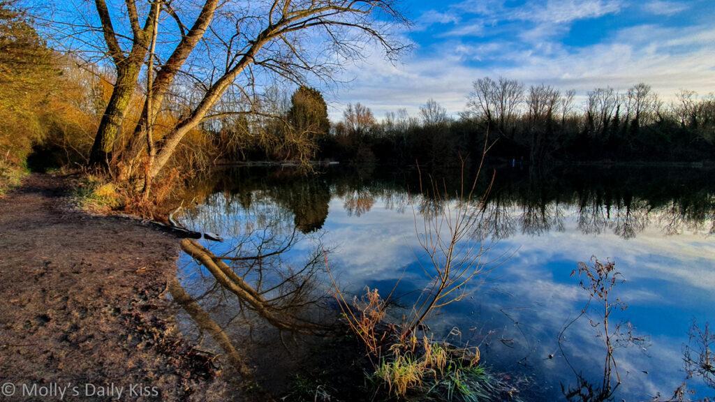 bue sky and clouds reflected in pond