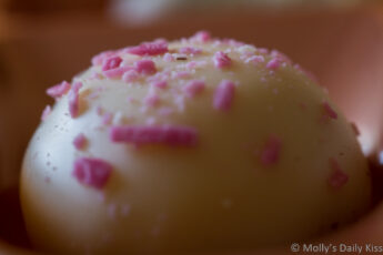 chemmically speaking.... a small white chocolate with pink flakes on top