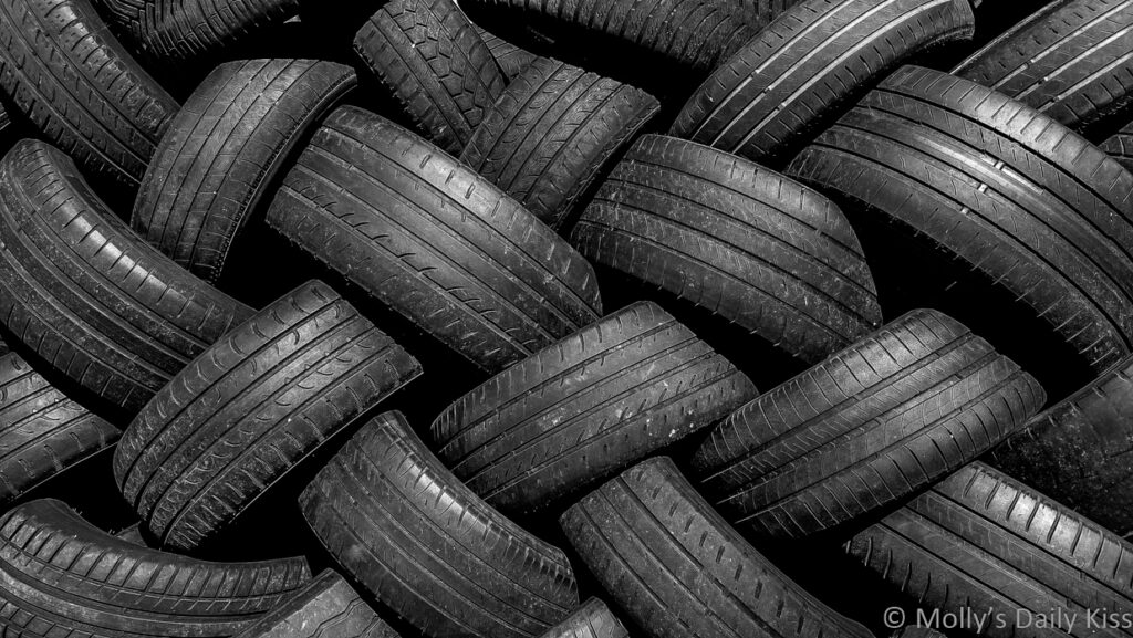 pile of tyres in black and white