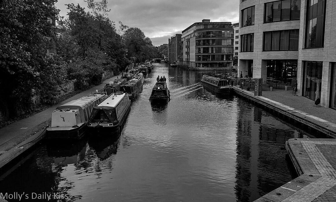 Boat moving down Regents canal at Kings Cross