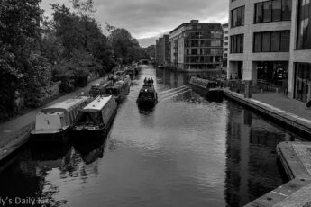 Boat moving down Regents canal at Kings Cross